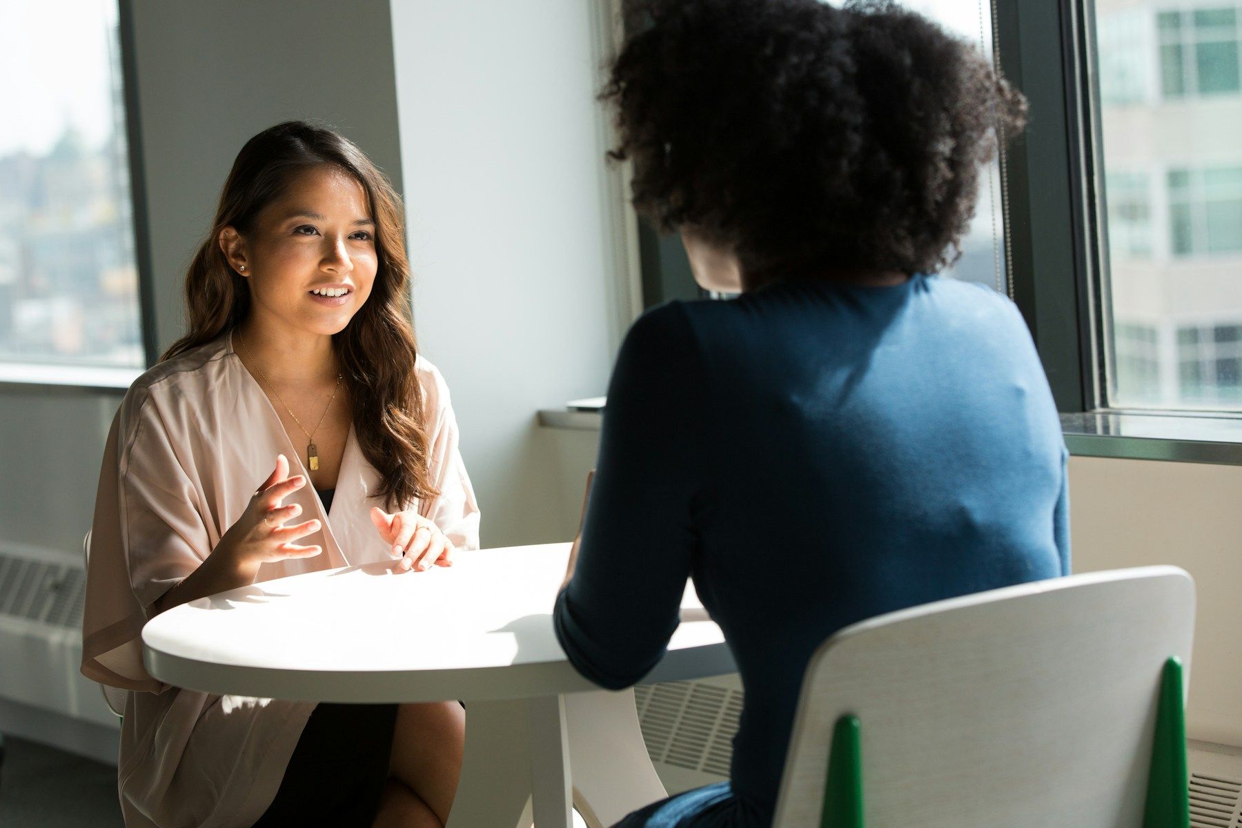 Two people talking through a project in a bright, modern office